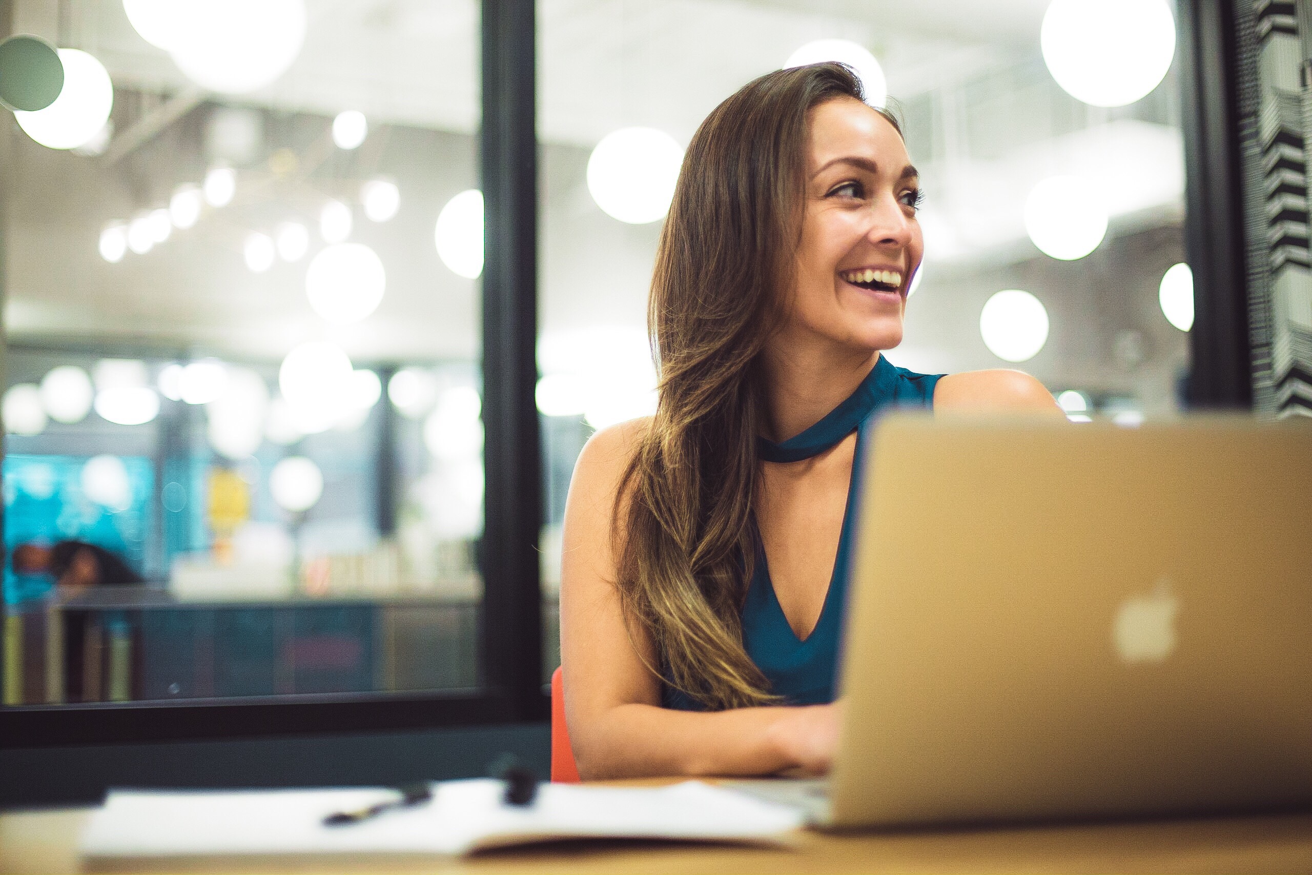 women smiling at laptop